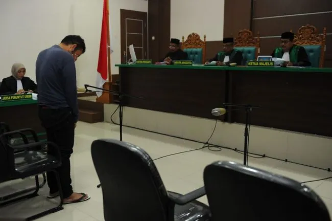 An Indonesian man attends his trial at a shariah court in Banda Aceh