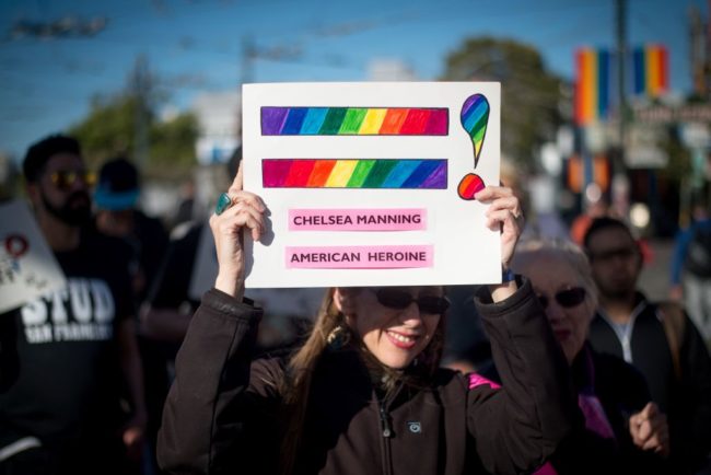 Holly Severson holds up a sign showing support for Chelsea Manning in the Castro District of San Francisco, California on May 17, 2017, during a celebration for Manning's release. Manning, the transgender army private jailed for one of the largest leaks of classified documents in US history, was released from a maximum-security prison in Kansas May 17, after seven years behind bars. / AFP PHOTO / Josh Edelson (Photo credit should read JOSH EDELSON/AFP/Getty Images)