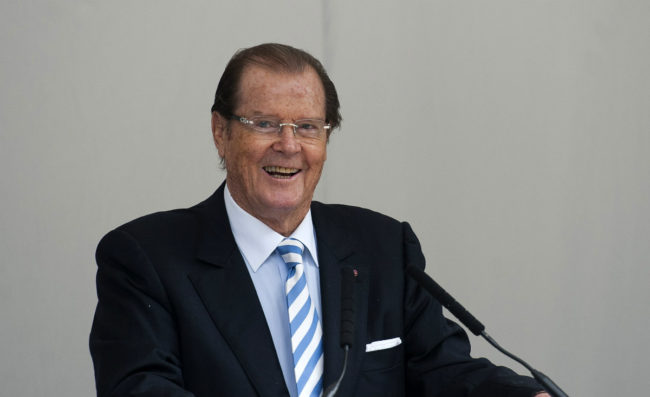 British film actor Roger Moore speaks at a memorial to the late film director and restaurant critic Michael Winner