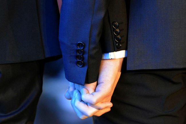 A gay couple holding hands. Two men were recently asked to leave a Wetherspoons for kissing