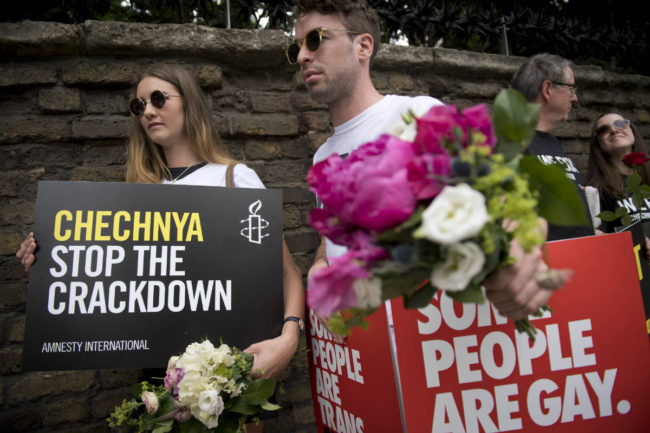 Demonstrators carry placards outside the Russian Embassy in London