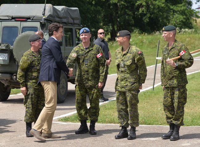 Justin trudeau shakes hands with instructor