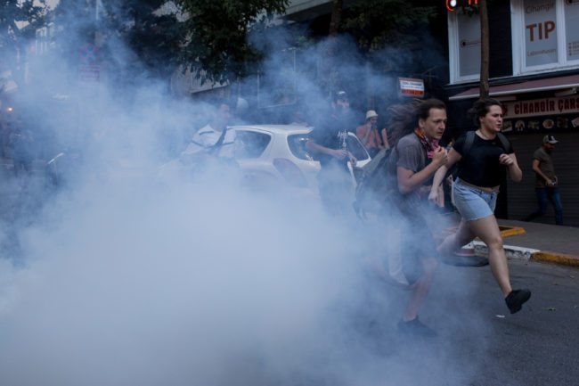 LGBT supporters run from tear gas fired by police after attempting to carry out the banned 2017 Istanbul Pride. (Photo by Chris McGrath/Getty Images)