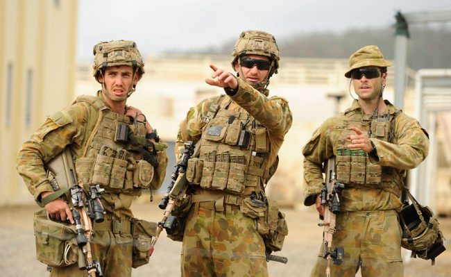 ROCKHAMPTON, AUSTRALIA - JULY 09: Australian soldiers from 7 Brigade discuss tactics as part of exercise Talisman Sabre on July 9, 2015 in Rockhampton, Australia. Talisman Sabre is a biennial military exercise that trains Australian and U.S. forces to plan and conduct combined task force operations to improve combat readiness and interoperability on a variety of missions from conventional conflict to peacekeeping and humanitarian assistance efforts. TS15 will incorporate force preparation activities, Special Forces activities, amphibious landings, parachuting, land force manoeuvre, urban operations, air operations, maritime operations and the coordinated firing of live ammunition and explosive ordnance from small arms, artillery, naval vessels and aircraft. (Photo by Ian Hitchcock/Getty Images)
