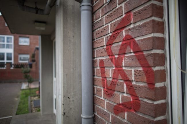 A swastika is sprayed at a asylum seeker accommodation in Waltrop, western Germany, on October 13, 2015. Four homes for asylum seekers in Waltrop were sprayed with swastikas during the night from October 12 to 13, 2015. AFP PHOTO / DPA / MAJA HITIJ  GERMANY OUT