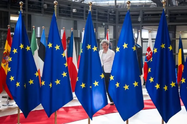 Theresa May and EU Flags
