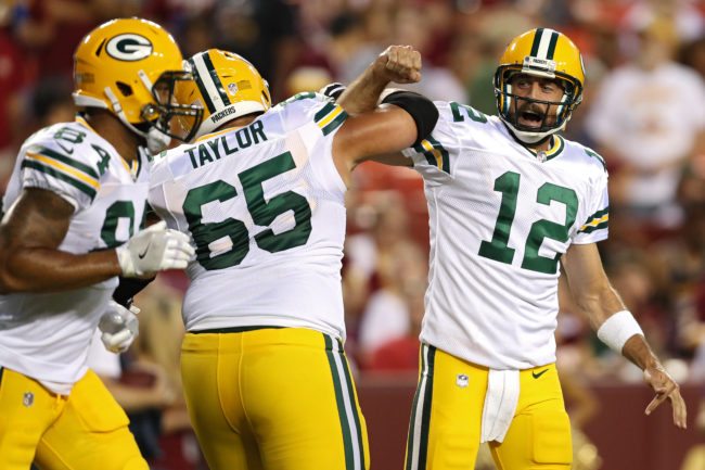 LANDOVER, MD - AUGUST 19: Quarterback Aaron Rodgers #12 of the Green Bay Packers celebrates a touchdown pass with teammate Lane Taylor #65 against the Washington Redskins in the first half during a preseason game at FedExField on August 19, 2017 in Landover, Maryland. (Photo by Patrick Smith/Getty Images)
