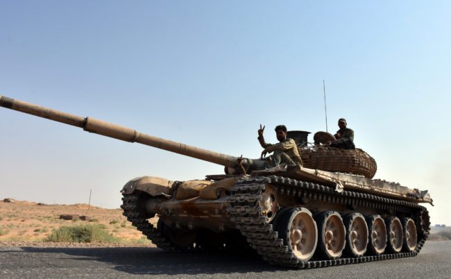 Syrian Government fighters on a tank