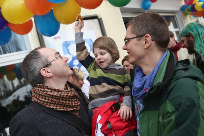 BERLIN, GERMANY - MARCH 15: Gay couple Kai (L) and Michael Korok and their daughter Jana, 4, attend the opening of Germany's first gay parent counseling center on March 15, 2013 in Berlin, Germany. The Regenbogenfamilien Zentrum (Rainbow Families Center) will provide counseling and other services to families with gay, lesbian and transgender parents. Gay marriage is legal in Germany though gay couples are not entitled to the same full legal rights as heterosexual couples, and the issue of child adoption by gay couples remains legally somewhat complicated. (Photo by Sean Gallup/Getty Images)