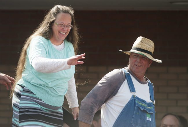 GRAYSON, KY - SEPTEMBER 8:  Rowan County Clerk of Courts Kim Davis (L) walks off stage with her husband Joe Davis (R) in front of the Carter County Detention Center on September 8, 2015 in Grayson, Kentucky. Davis was ordered to jail last week for contempt of court after refusing a court order to issue marriage licenses to same-sex couples. (Photo by Ty Wright/Getty Images)