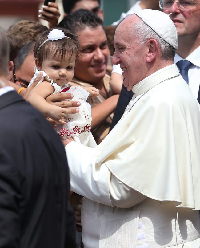 SANTIAGO DE CUBA, CUBA - SEPTEMBER 22:  Pope Francis holds a baby as he leaves the cathedral after holding a mass and blessing the city on September 22, 2015 in Santiago de Cuba, Cuba. Pope Francis leaves for the United States after spending four days in Cuba.  (Photo by Joe Raedle/Getty Images)