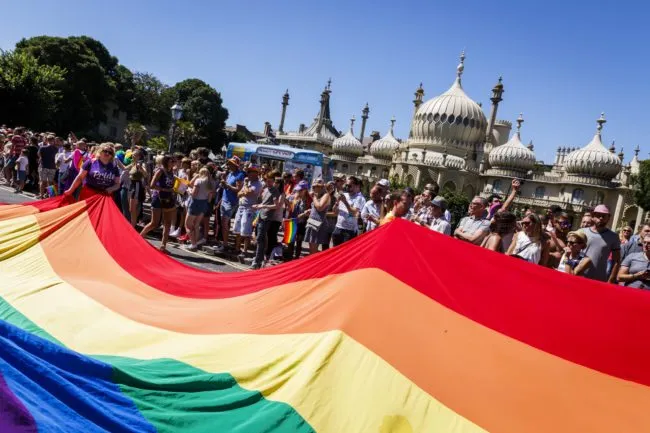 BRIGHTON, ENGLAND - AUGUST 06: The rainbow flag is carried through the streets at the Brighton Pride Parade on August 6, 2016 in Brighton, England. (Photo by Tristan Fewings/Getty Images)