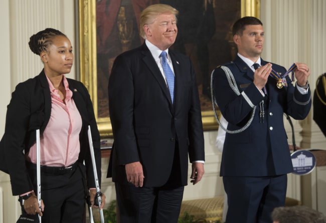 US President Donald Trump presents the Medal of Valor to US Capitol Police Officer Crystal Griner during a ceremony honoring the first responders of the June 14 shooting against members of the Republican Congressional Baseball team, where US House Majority Whip Representative Steve Scalise, Republican of Louisiana, was shot, in the East Room of the White House in Washington, DC, July 27, 2017. / AFP PHOTO / SAUL LOEB        (Photo credit should read SAUL LOEB/AFP/Getty Images)