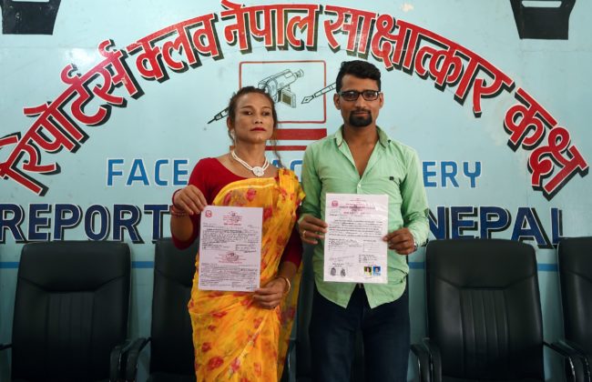 Nepali transgender woman Monika Shahi Nath (L) and her husband Ramesh Nath (R) pose fpor pictures with their marriage certificate after announcing the registration of their marriage at a press conference in Kathmandu on August 5, 2017.  A Nepali transgender woman and a man registered their marriage, a first in the country, the couple said on August 5, despite an absence of laws legalising same-sex or transgender unions. Monika Shahi Nath, 40, who legally identifies as a third gender, married Ramesh Nath Yogi, 22, in May and was able to register it in their home district Dadeldhura in western Nepal last month. / AFP PHOTO / PRAKASH MATHEMA        (Photo credit should read PRAKASH MATHEMA/AFP/Getty Images)