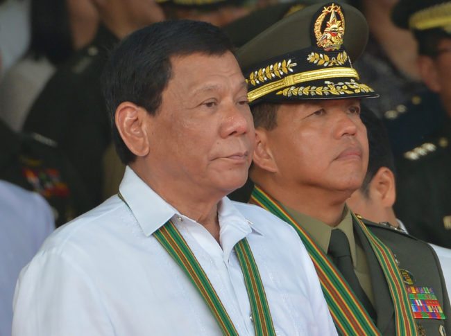 Philippine President Rodrigo Duterte (L) stands next to newly-installed army commanding general Major General Rolando Bautista (R) during the turn-over ceremony of the army commanding general at Fort Bonifacio in Manila on October 5, 2017. Newly installed army commanding general Major General Rolando Bautista said in his speech the army hopes to end the war in Marawi at the end of October. / AFP PHOTO / TED ALJIBE (Photo credit should read TED ALJIBE/AFP/Getty Images)