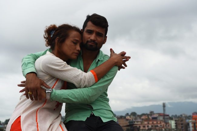 This photo taken on August 3, 2017 shows Nepali transgender person Monika Shahi Nath and her husband Ramesh Nath Yogi posing for a picture in Kathmandu. Monika Shahi Nath, 40, became Nepal's first transgender person to be issued with a marriage certificate by district officials when she married 22-year-old Ramesh Nath Yogi in May, even though Nepal has no formal laws for such unions. The couple have found a rare acceptance in Nepal, where many transgender people still struggle to be open about their identity despite progressive laws that include a third gender option on identity cards and passports. / AFP PHOTO / Prakash MATHEMA / TO GO WITH Nepal-transgender-marriage-rights        (Photo credit should read PRAKASH MATHEMA/AFP/Getty Images)