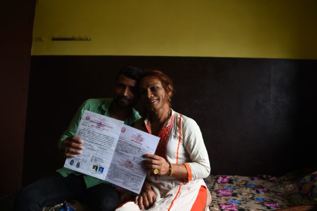 This photo taken on August 3, 2017 shows Nepali transgender person Monika Shahi Nath and her husband Ramesh Nath Yogi holding their marriage certificate in Kathmandu. Monika Shahi Nath, 40, became Nepal's first transgender person to be issued with a marriage certificate by district officials when she married 22-year-old Ramesh Nath Yogi in May, even though Nepal has no formal laws for such unions. The couple have found a rare acceptance in Nepal, where many transgender people still struggle to be open about their identity despite progressive laws that include a third gender option on identity cards and passports. / AFP PHOTO / Prakash MATHEMA / TO GO WITH Nepal-transgender-marriage-rights        (Photo credit should read PRAKASH MATHEMA/AFP/Getty Images)
