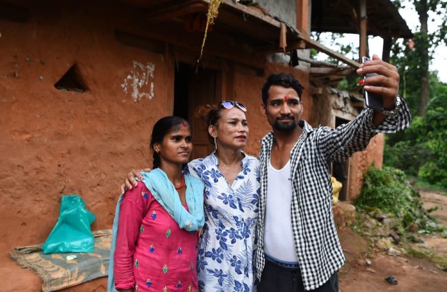 This photo taken on August 22, 2017 shows Nepali transgender person Monika Shahi Nath Yogi (C) posing with her husband Ramesh Nath Yogi and his first wife Laxmi Nath Yogi (L) at Kain Pani village in Nepal's Dadeldhura district. Monika Shahi Nath, 40, became Nepal's first transgender person to be issued with a marriage certificate by district officials when she married 22-year-old Ramesh Nath Yogi in May, even though Nepal has no formal laws for such unions. The couple have found a rare acceptance in Nepal, where many transgender people still struggle to be open about their identity despite progressive laws that include a third gender option on identity cards and passports. / AFP PHOTO / Prakash MATHEMA / TO GO WITH Nepal-transgender-marriage-rights        (Photo credit should read PRAKASH MATHEMA/AFP/Getty Images)