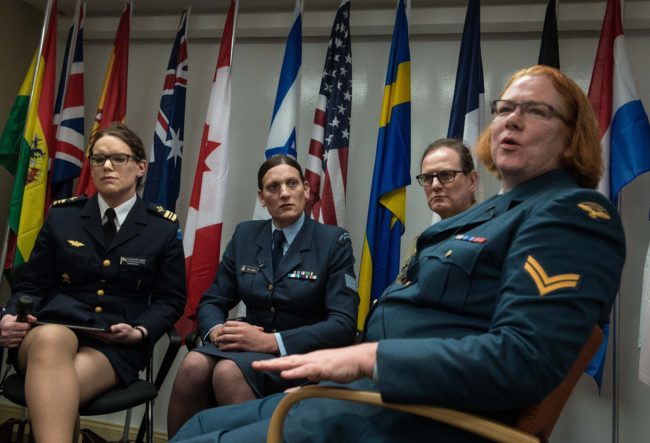 Major Alexandra Larsson of the Swedish Armed Forces, Sergeant Lucy Jordan of the New Zealand Air Force and Major Donna Harding of the Royal Australian Army Nursing Corps listen to Corporal Natalie Murray of the Canadian Forces