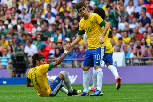 Brazil's midfielder Oscar (R) helps Brazil's forward Neymar to stand up as they play in the men's football final match between Brazil and Mexico at Wembley stadium during the London Olympic Games on August 11, 2012. AFP PHOTO / LUIS ACOSTA (Photo credit should read LUIS ACOSTA/AFP/GettyImages)