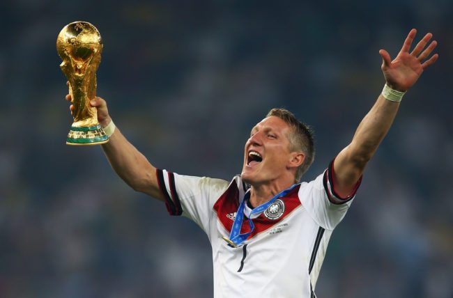RIO DE JANEIRO, BRAZIL - JULY 13:  Bastian Schweinsteiger of Germany celebrates with the World Cup trophy after defeating Argentina 1-0 in extra time during the 2014 FIFA World Cup Brazil Final match between Germany and Argentina at Maracana on July 13, 2014 in Rio de Janeiro, Brazil.  (Photo by Clive Rose/Getty Images)