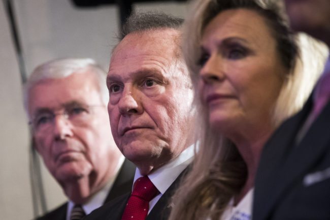BIRMINGHAM, AL - NOVEMBER 16: Republican candidate for U.S. Senate Judge Roy Moore, sitting next to his wife Kayla Moore, waits to speak at a news conference with supporters and faith leaders, November 16, 2017 in Birmingham, Alabama. Moore refused to answer questions regarding sexual harassment allegations and pursuing relationships with underage women. (Drew Angerer/Getty Images)