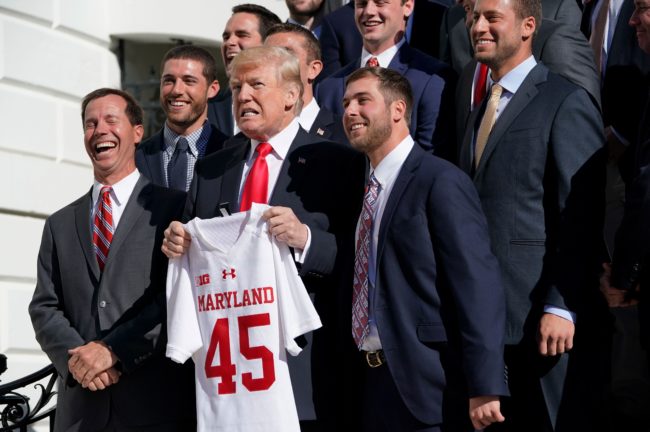 US President Donald Trump poses with members of the University of Maryland lacrosse team during an event honoring NCAA national championship teams on November 17, 2017 in Washington, DC. / AFP PHOTO / Mandel NGAN (Photo credit should read MANDEL NGAN/AFP/Getty Images)