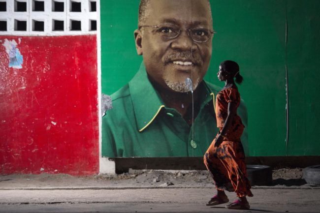 A woman walks past an election billboard after ruling party Chama Cha Mapinduzi (CCM) candidate John Magufuli (pictured on the billboard) was named president-elect by the National Electoral Commission in Dar es Salaam, on October 29, 2015. Opposition party Chadema presidential candidate Edward Lowassa has rejected the election results and has filed an official petition against the National Electoral Commission. The win by Magufuli with over 58 percent of votes cements the long-running Chama Cha Mapinduzi (CCM) party's firm grip on power, ruling Tanzania since 1977 when two independence-era parties merged. AFP PHOTO / DANIEL HAYDUK (Photo credit should read Daniel Hayduk/AFP/Getty Images)