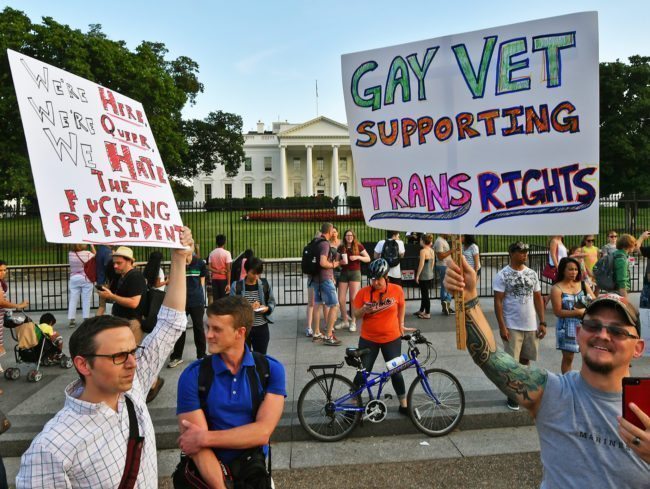 Protesters gather in front of the White House July 26, 2017, in Washington, DC. Trump announced on July 26 that transgender people may not serve "in any capacity" in the US military, citing the "tremendous medical costs and disruption" their presence would cause. / AFP PHOTO / PAUL J. RICHARDS (Photo credit should read PAUL J. RICHARDS/AFP/Getty Images)