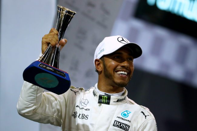 ABU DHABI, UNITED ARAB EMIRATES - NOVEMBER 26:  Second place finisher Lewis Hamilton of Great Britain and Mercedes GP celebrates with his trophy on the podium during the Abu Dhabi Formula One Grand Prix at Yas Marina Circuit on November 26, 2017 in Abu Dhabi, United Arab Emirates.  (Photo by Dan Istitene/Getty Images)