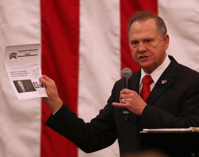 MIDLAND CITY, AL - DECEMBER 11:  Republican Senatorial candidate Roy Moore holds up a print out of a news story as he speaks during a campaign event at Jordan's Activity Barn on December 11, 2017 in Midland City, Alabama. Mr. Moore is facing off against Democrat Doug Jones in tomorrow's special election for the U.S. Senate.  (Photo by Joe Raedle/Getty Images)