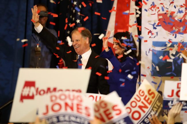 BIRMINGHAM, AL - DECEMBER 12: Democratic U.S. Senator elect Doug Jones (L) and wife Louise Jones (R) greet supporters during his election night gathering the Sheraton Hotel on December 12, 2017 in Birmingham, Alabama. Doug Jones defeated his republican challenger Roy Moore to claim Alabama's U.S. Senate seat that was vacated by attorney general Jeff Sessions. (Photo by Justin Sullivan/Getty Images)