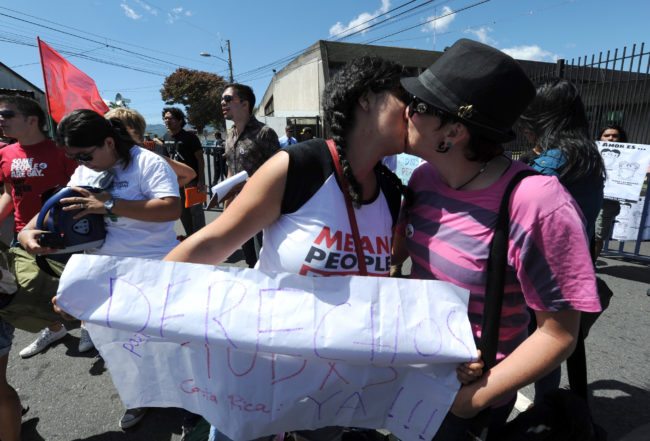 Members of gay and lesbian organizations kiss during a demonstration in front of the Presidential Palace in San Jose on February 14, 2012. About one hundred Costa Rican gays rallied outside the government house to ask President Laura Chinchilla for a law legalizing the homosexual unions. AFP PHOTO/Rodrigo ARANGUA (Photo credit should read RODRIGO ARANGUA/AFP/Getty Images)