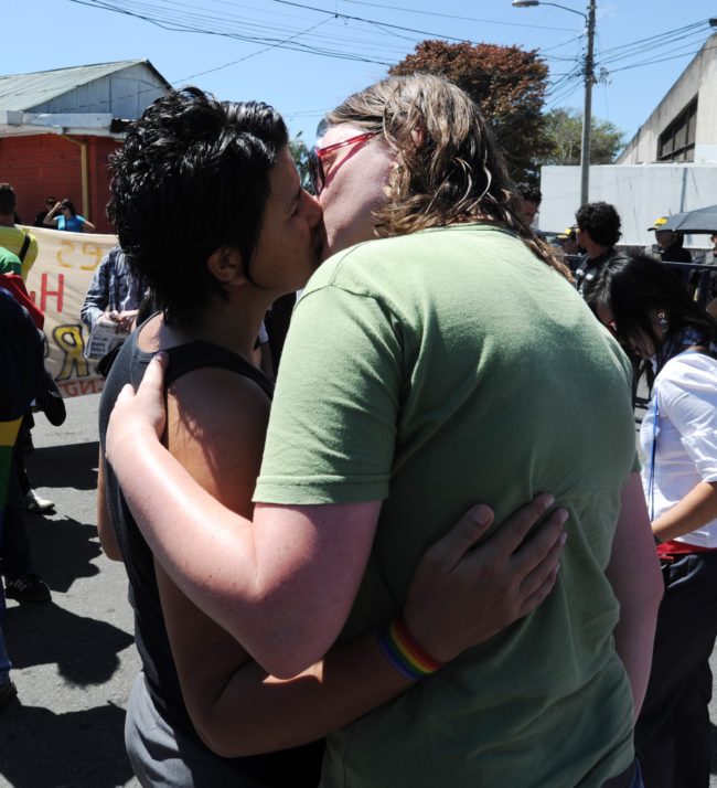 Members of gay and lesbian organizations kiss during a demonstration in front of the Presidential Palace in San Jose on February 14, 2012. About one hundred Costa Rican gays rallied outside the government house to ask President Laura Chinchilla for a law legalizing the homosexual unions. AFP PHOTO/Rodrigo ARANGUA (Photo credit should read RODRIGO ARANGUA/AFP/Getty Images)