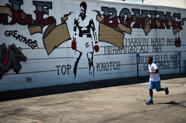 Curtis Knight, 13, runs laps outside the Louisville TKO Boxing Gymnasium on June 6, 2016 in Louisville, Kentucky. The family of late boxing legend Muhammad Ali and the city of Louisville prepared for his public funeral later this week, which organizers said "The Greatest" helped plan himself as a "last statement" to the world. Ali was born and raised in Louisville, Kentucky. / AFP / Brendan Smialowski (Photo credit should read BRENDAN SMIALOWSKI/AFP/Getty Images)