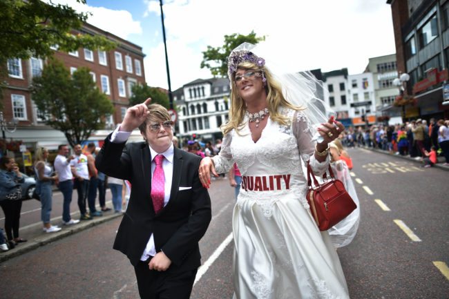 BELFAST, NORTHERN IRELAND - AUGUST 05: A drag queen and a participant dressed as Donald Trump wave to the cowd as Belfast Gay Pride takes place on August 5, 2017 in Belfast, Northern Ireland. The province is the only part of the United Kingdom which does not recognise same sex marriage. The Irish Republic's first gay prime minister Taoiseach Leo Varadkar today predicted it is only a matter of time before same sex marriage is legalised in the north. Mr Varadkar was speaking at a Pride breakfast event. (Photo by Charles McQuillan/Getty Images)
