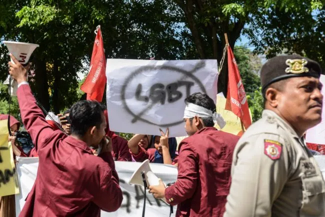 A group of Muslim protesters march with banners against the lesbian, gay, bisexual and transgender (LGBT) community in Banda Aceh on Decmber 27, 2017.  There has been a growing backlash against Indonesia's small lesbian, gay, bisexual and transgender (LGBT) community over the past year, with ministers, hardliners and influential Islamic groups lining up to make anti-LGBT statements in public. / AFP PHOTO / Chaideer MAHYUDDIN. (Photo credit should read CHAIDEER MAHYUDDIN/AFP/Getty Images)