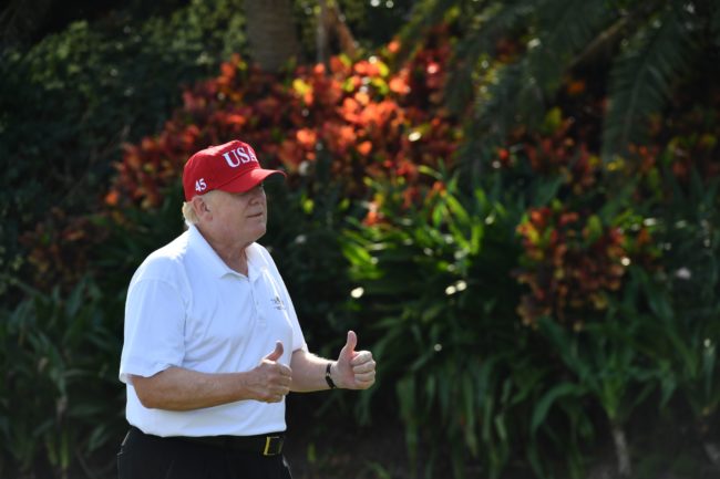 US President Donald Trump holds two thumbs up while meeting with service members of the United States Coast Guard to play golf at Trump International Golf Course in Mar-a-Lago, Florida on December 29, 2017. The President invited members of the Coast Guard to play golf to thank them personally for their service of patrolling the waters near Palm Beach and Mar-a-Lago. / AFP PHOTO / Nicholas Kamm        (Photo credit should read NICHOLAS KAMM/AFP/Getty Images)
