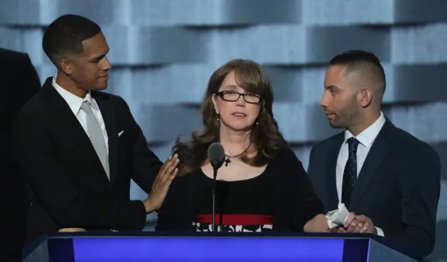 PHILADELPHIA, PA - JULY 27:  Christine Leinonen, mother of Christopher 'Dru' Leinonen, is comforted by Brandon Wolf (L) and Jose Arriagada (R), survivors of the attack at the Pulse nightclub in Orlando, as they stand on stage during the third day of the Democratic National Convention at the Wells Fargo Center, July 27, 2016 in Philadelphia, Pennsylvania. Democratic presidential candidate Hillary Clinton received the number of votes needed to secure the party's nomination. An estimated 50,000 people are expected in Philadelphia, including hundreds of protesters and members of the media. The four-day Democratic National Convention kicked off July 25.  (Photo by Alex Wong/Getty Images)