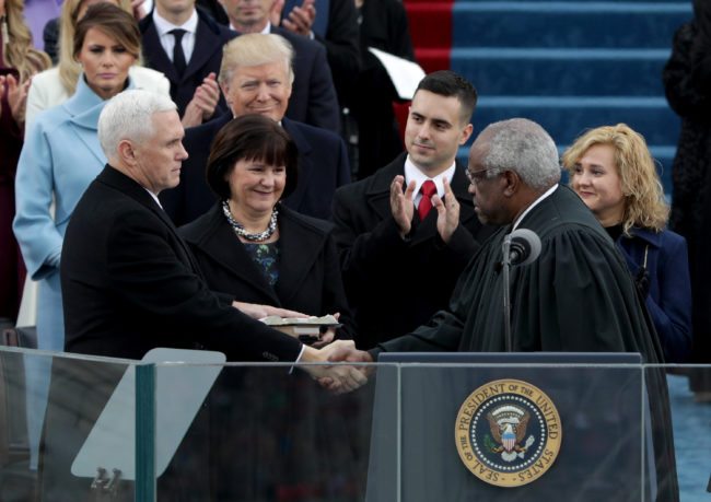 WASHINGTON, DC - JANUARY 20:  Vice President Mike Pence shakes hands with Supreme Court Justice Clarence Thomas as wife Karen Pence holds a bible on the West Front of the U.S. Capitol on January 20, 2017 in Washington, DC. In today's inauguration ceremony Donald J. Trump becomes the 45th president of the United States.  (Photo by Alex Wong/Getty Images)