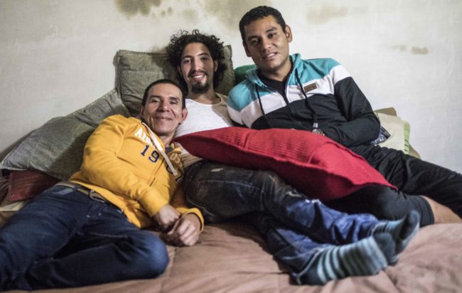 Alejandro Rodriguez (L), Victor Prada (C) and Manuel Bermudez pose for a photo at their home in Medellin, Colombia on June 17, 2017. The three men have gained legal recognition as the first "polyamorous family" in the country , where same-sex marriages were legalized last year. / AFP PHOTO / JOAQUIN SARMIENTO (Photo credit should read JOAQUIN SARMIENTO/AFP/Getty Images)