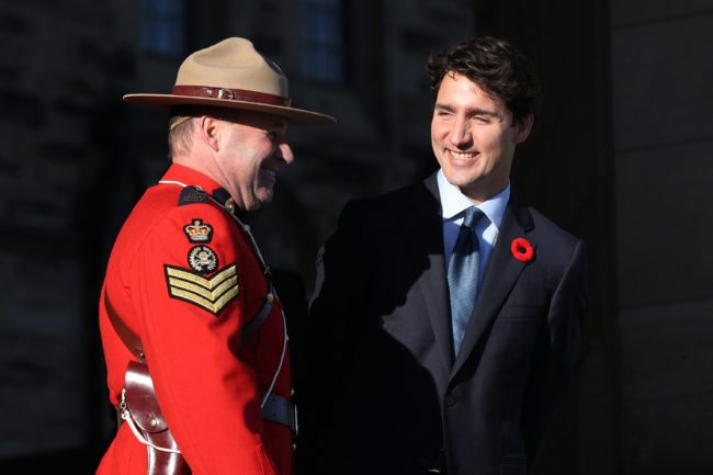 Canadian Prime Minister Justin Trudeau speaks with an RCMP officer before the arrival of the Colombian President Juan Manuel Santos Calderon on Parliament Hill in Ottawa, Ontario, October 30, 2017. / AFP PHOTO / Lars Hagberg (Photo credit should read LARS HAGBERG/AFP/Getty Images)