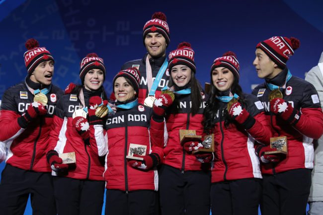 PYEONGCHANG-GUN, SOUTH KOREA - FEBRUARY 12: Gold medalists (L-R) Scott Moir, Tessa Virtue, Meagan Duhamel, Eric Radford, Kaetlyn Osmond, Gabrielle Daleman, and Patrick Chan of Team Canada celebrate during the medal ceremony after the Figure Skating Team Event at Medal Plaza on February 12, 2018 in Pyeongchang-gun, South Korea. (Photo by Andreas Rentz/Getty Images)