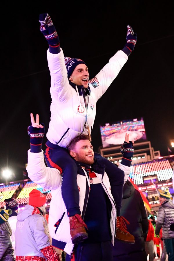 TOPSHOT - US athletes Adam Rippon and Gus Kenworthy parade with other delegations during the closing ceremony of the Pyeongchang 2018 Winter Olympic Games at the Pyeongchang Stadium on February 25, 2018. / AFP PHOTO / Jonathan NACKSTRAND        (Photo credit should read JONATHAN NACKSTRAND/AFP/Getty Images)