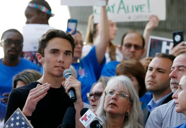 (FILES) File photo dated February 17, 2018 shows Marjory Stoneman Douglas High School student David Hogg speaking at a rally for gun control at the Broward County Federal Courthouse in Fort Lauderdale, Florida. A former student, Nikolas Cruz, opened fire at the high school leaving 17 people dead and 15 injured on February 14. / AFP PHOTO / RHONA WISE (Photo credit should read RHONA WISE/AFP/Getty Images)