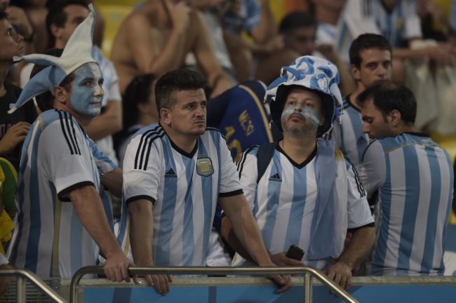 Argentinian supporters look on after their team's defeat in the final football match between Germany and Argentina for the FIFA World Cup at The Maracana Stadium in Rio de Janeiro on July 13, 2014. AFP PHOTO / JUAN MABROMATA (Photo credit should read JUAN MABROMATA/AFP/Getty Images)
