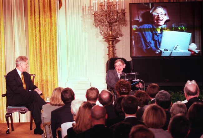 WASHINGTON, : US President Bill Clinton (L) and Professor Stephen Hawking -- in person and on screen -- watch a scene from "Star Trek the Next Generation", during a "Millennium Evening" at the White House 06 March in Washington DC. Theoretical physicist Hawking talked about the future of science during the live telecast with the Clintons. AFP PHOTO Tim SLOAN (Photo credit should read TIM SLOAN/AFP/Getty Images)