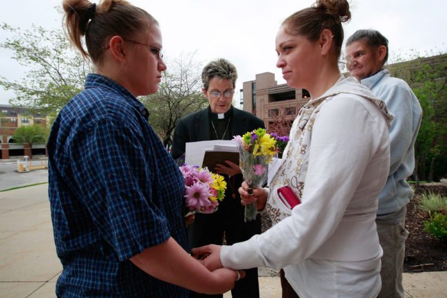 DES MOINES, IA - APRIL 27: Jodie Vandermark-Martinez (R) is married to her partner Jessica during a ceremony performed by Rev. Peg Esperanza (C) on the steps of the Polk County Administration Building April 27, 2009 in Des Moines, Iowa. Today was the first day gay couples were allowed to marry in the state following an April 3, 2009 ruling by the Iowa Supreme Court which declared a legislative ban on same-sex marriage unconstitutional. (Photo by Scott Olson/Getty Images)