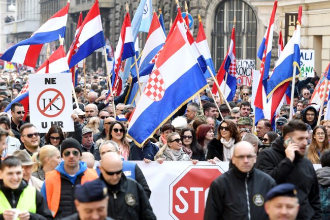 Opponents to a treaty safeguarding women, backed by the Roman Catholic Church, protest against its ratification arguing it is imposing what they call a "gender ideology in the Croatian capital, Zagreb, on March 24, 2018. Protestors against the Council of Europe convention -- the world's first binding instrument to prevent and combat violence against women, from marital rape to female genital mutilation -- hold banners against its ratification, an issue that has split the Balkan country.  / AFP PHOTO / STR        (Photo credit should read STR/AFP/Getty Images)