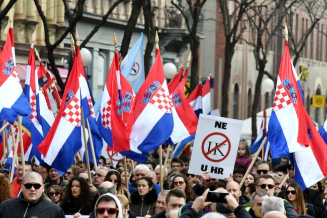 Opponents to a treaty safeguarding women, backed by the Roman Catholic Church, protest against its ratification arguing it is imposing what they call a "gender ideology" in the Croatian capital, Zagreb, on March 24, 2018. Protestors against the Council of Europe convention on preventing and combating violence against women and domestic violence (Istanbul Convention) -- the world's first binding instrument to prevent and combat violence, from marital rape to female genital mutilation -- hold banners against its ratification, an issue that has split the Balkan country.  / AFP PHOTO / STR        (Photo credit should read STR/AFP/Getty Images)